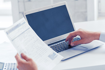 Image showing miling businessman working in office