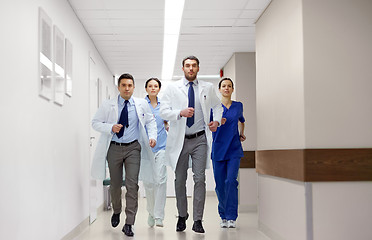 Image showing group of medics walking along hospital