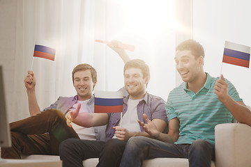 Image showing happy male friends with flags and vuvuzela