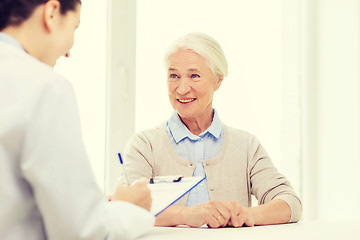 Image showing doctor with clipboard and senior woman at hospital