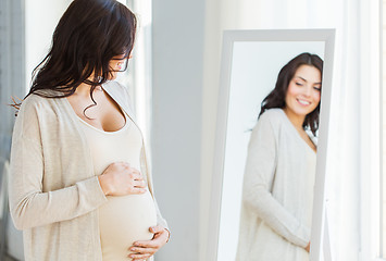 Image showing close up of pregnant woman looking to mirror