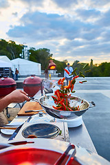 Image showing chef tossing vegetables in a wok