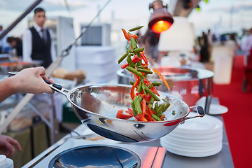 Image showing chef tossing vegetables in a wok