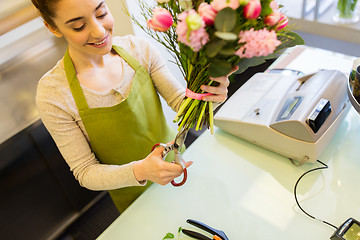 Image showing close up of woman with flowers and scissors