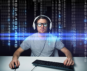 Image showing man in headset hacking computer or programming