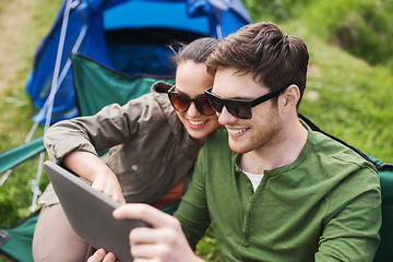 Image showing happy couple with tablet pc at camping tent