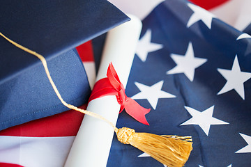 Image showing bachelor hat and diploma on american flag