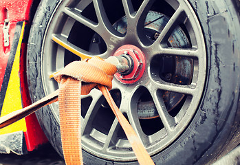 Image showing close up of race car wheel with tow rope tied to