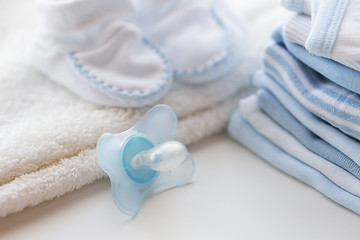 Image showing close up of soother and baby clothes for newborn