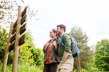 Image showing smiling couple with backpacks hiking