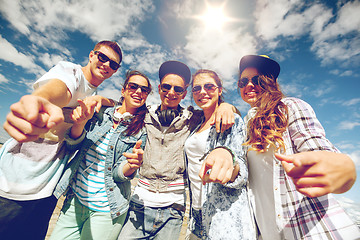 Image showing smiling teenagers in sunglasses hanging outside