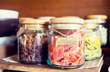 Image showing close up of jars with dried fruits at grocery