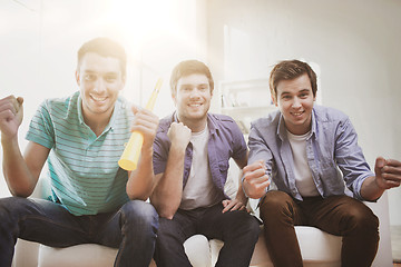 Image showing happy male friends with vuvuzela