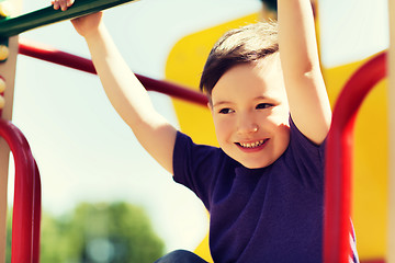 Image showing happy little boy climbing on children playground