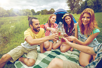 Image showing happy friends with tent and drinks at campsite