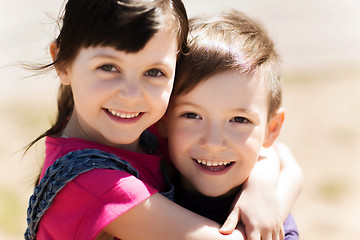 Image showing two happy kids hugging outdoors