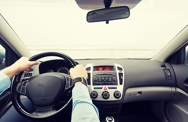 Image showing close up of young man driving car