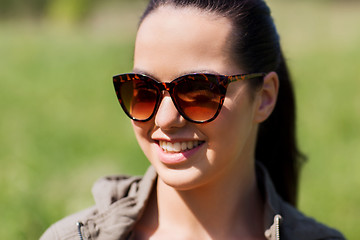 Image showing face of happy young woman in sunglasses outdoors