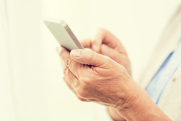 Image showing close up of senior woman with smartphone texting