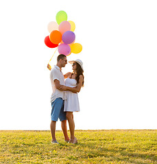 Image showing smiling couple with air balloons outdoors