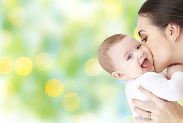 Image showing happy mother kissing adorable baby