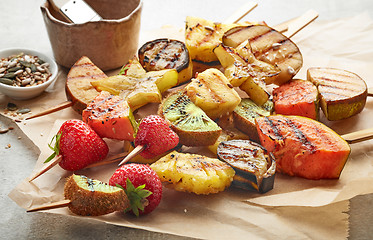 Image showing grilled fruit pieces on wooden skewers