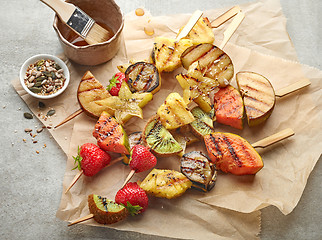 Image showing grilled fruit pieces on wooden skewers