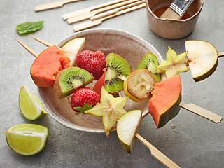 Image showing fresh berries and fruit pieces on skewers
