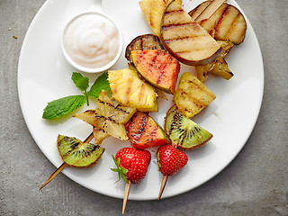 Image showing grilled fruits on wooden skewers