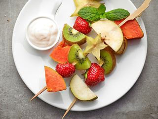 Image showing fresh berries and fruit pieces on skewers