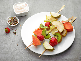 Image showing fresh berries and fruit pieces on skewers