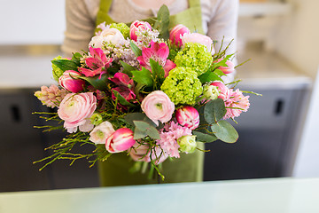 Image showing close up of woman holding bunch at flower shop