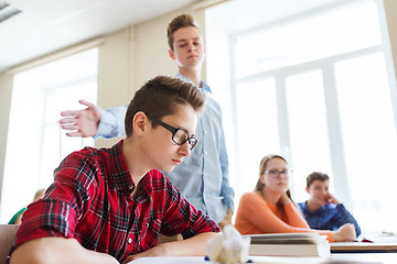 Image showing classmate offending student boy at school