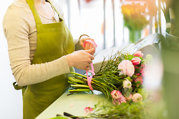 Image showing close up of woman making bunch at flower shop