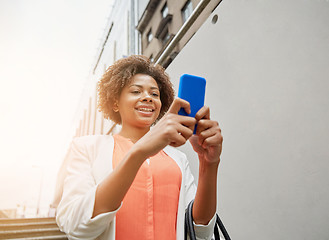 Image showing happy african woman with smartphone in city