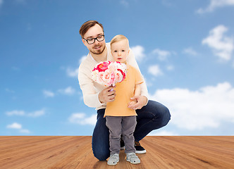 Image showing happy father and son with bunch of flowers