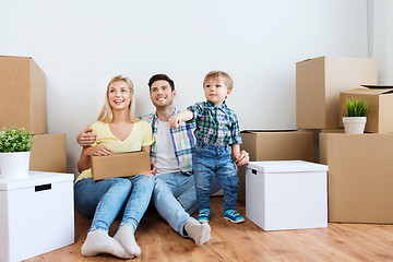 Image showing happy family with boxes moving to new home