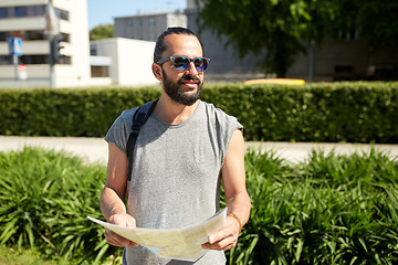 Image showing man traveling with backpack and map in city