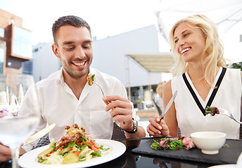 Image showing happy couple eating dinner at restaurant terrace