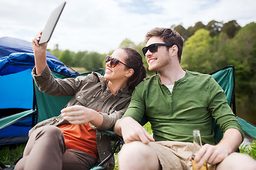 Image showing happy couple with tablet pc at camping tent