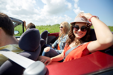 Image showing happy friends driving in cabriolet car