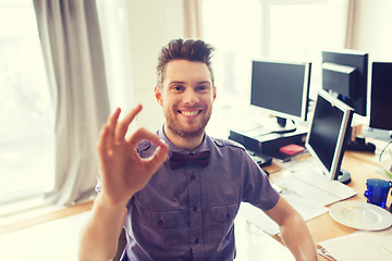 Image showing happy creative male office worker showing ok sign