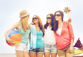 Image showing smiling girls in shades having fun on the beach