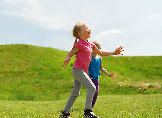 Image showing group of happy kids running outdoors