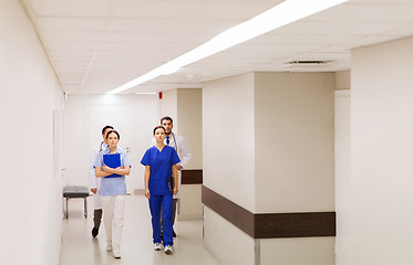 Image showing group of medics or doctors walking along hospital