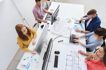 Image showing creative team with computers, blueprint at office