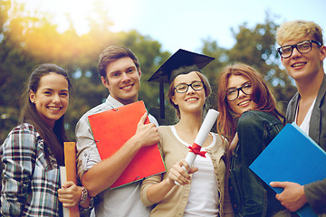 Image showing group of smiling students with diploma and folders