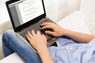 Image showing close up of man typing on laptop computer at home