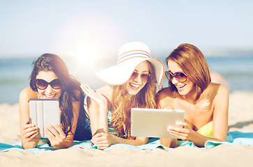 Image showing girls with tablet pc on the beach