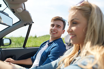 Image showing happy couple driving in cabriolet car outdoors